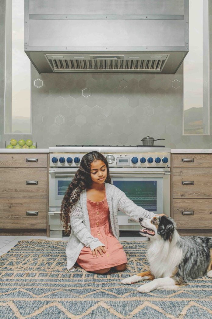 Girl with dog in luxury kitchen