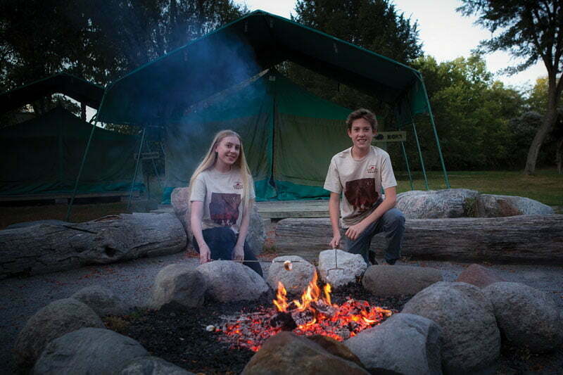 A bonfire with two young people at Toronto Zoo